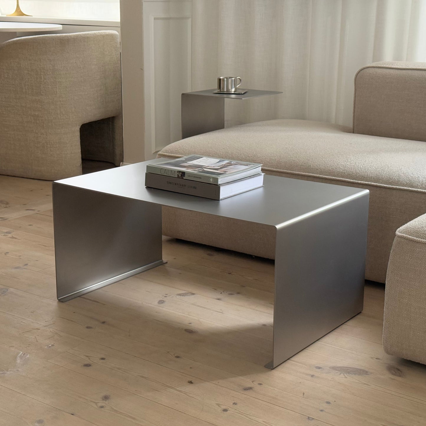Angled view showing the Elegance Coffee Table with the Elegance Side Table in the background.