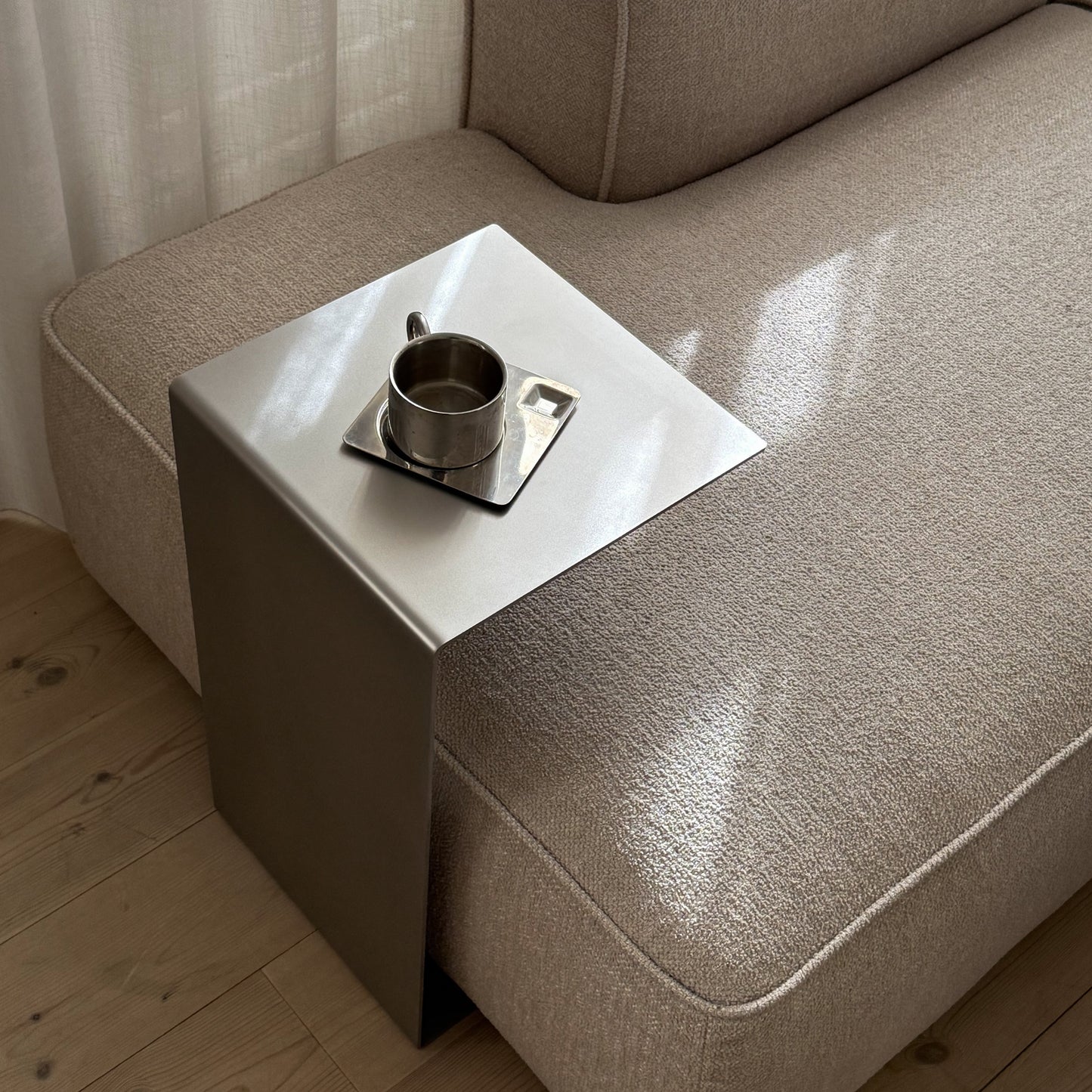 Angled view of the Elegance Side Table highlighting its satin-matte surface and proportions.